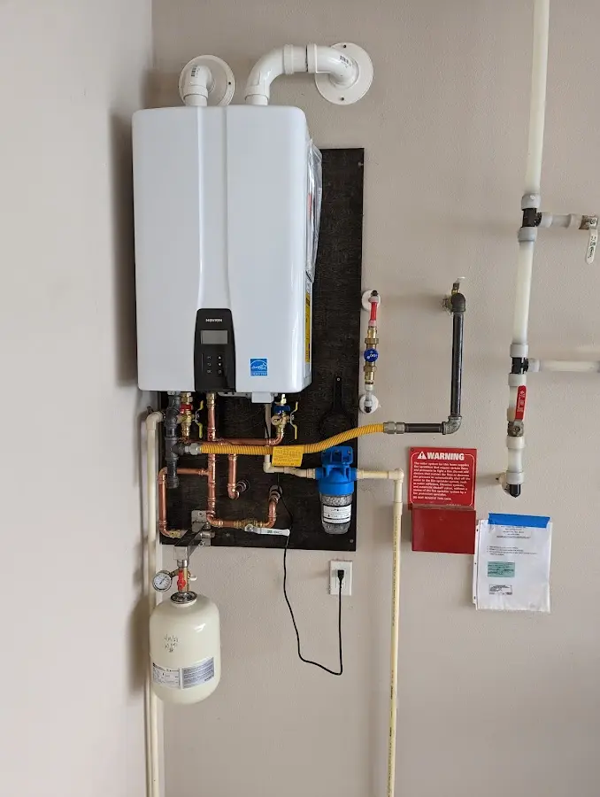 Professional plumber installing copper piping in a Baldwyn home